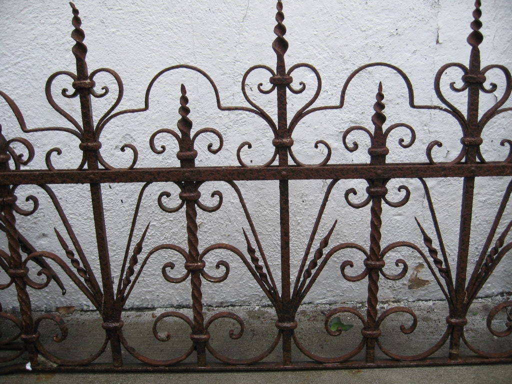 Very ornate fence. Used for guarding and keeping plants within a vicinity.