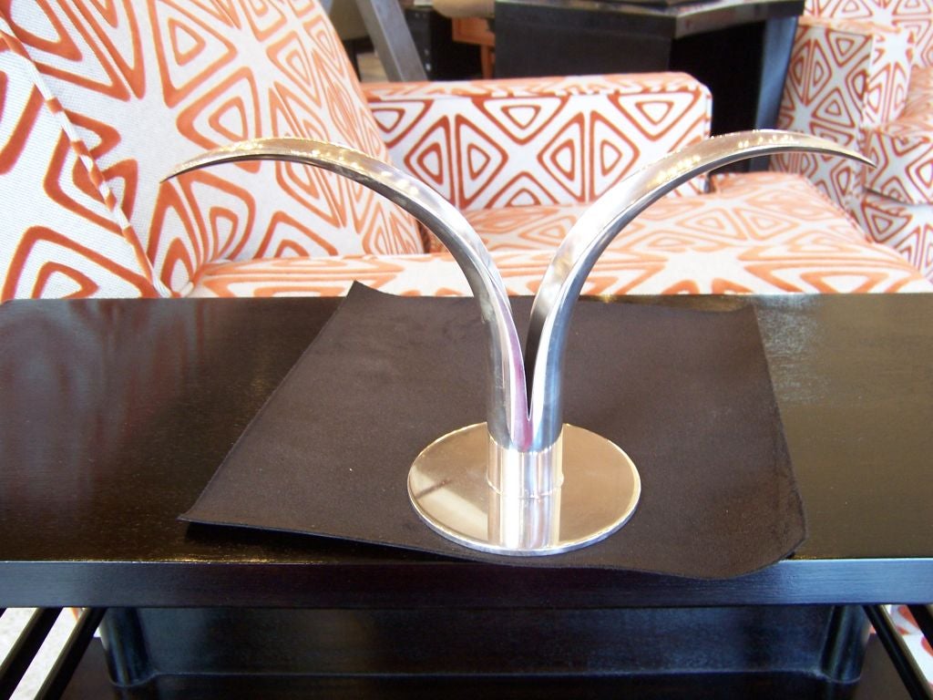 Sculptural elegance, this pair of mid century candle sticks are the perfect accent to any room! Polished nickle finish.