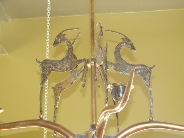 Bronze chandelier with Alpine Ibex or gazelle motif, and larger sweeping horns holding the bobeches.