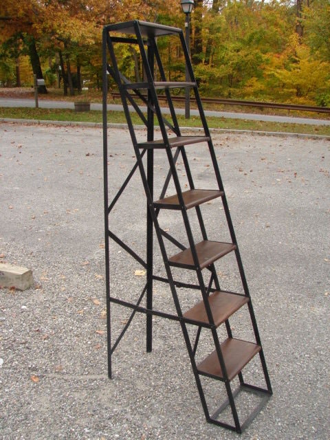 Patinated steel library ladder with oak plank steps.