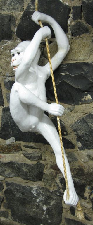 Large, playful ceramic monkey sculpture which hangs from a rope.  Stamped MADE IN FRANCE on bottom.