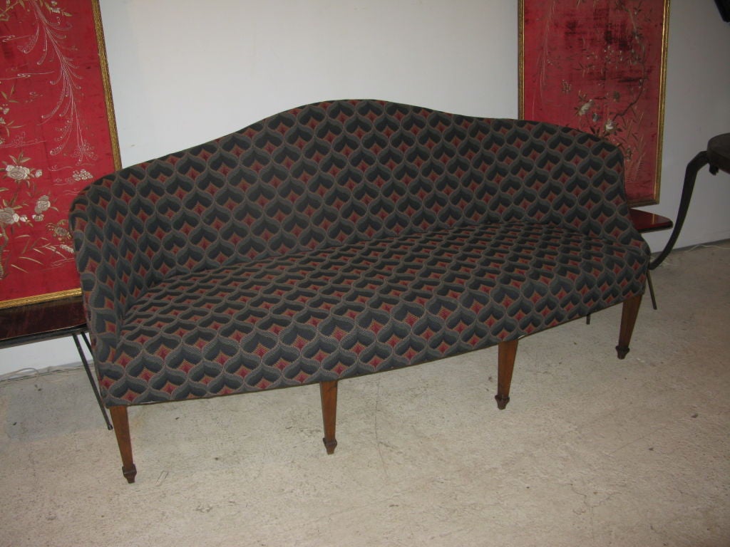 Great American mahogany camel-back sofa, with well-scaled curved frame, supported by four square-tapered carved front legs, and three square-flared back legs. Very comfortable with original custom material.