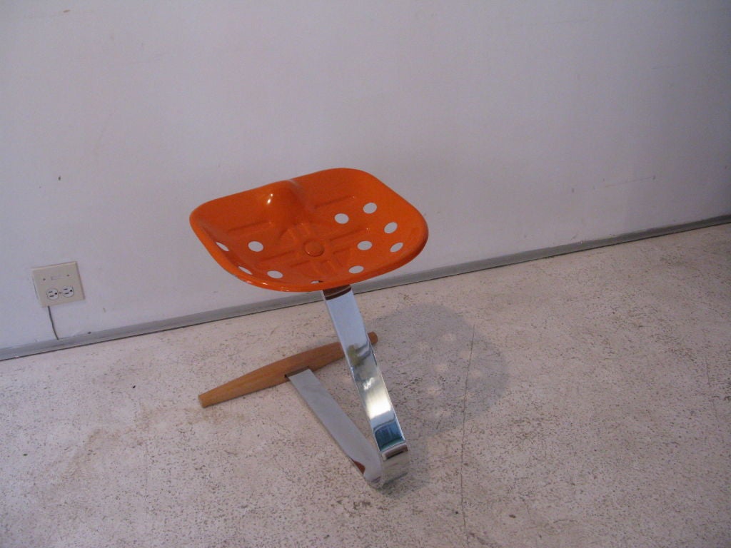 Mezzadro tractor seat designed by Achille and PierGiacomo Castiglioni for Zanotta,in stamp/molded orange metal seat supported by chromed steel and wood base.Stamped logo by maker.Documented.