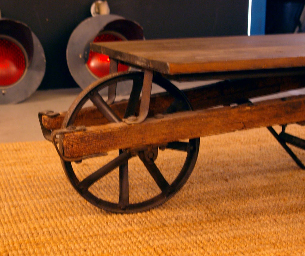 20th-century wheelbarrow turned into a pretty (and) handy coffee table with distressed wood top.