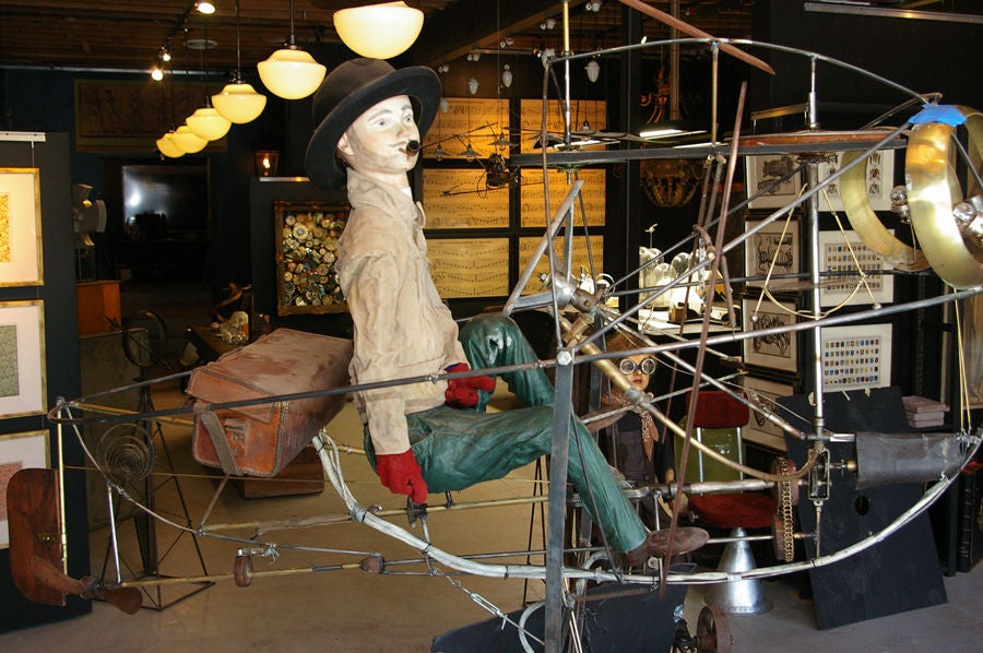 Flying Boy With Pipe on Cycling Contraption