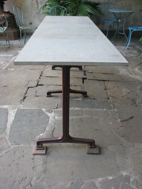 Exceptionally long French Belle Epoque cast iron bistro table with grey marble top, marked 