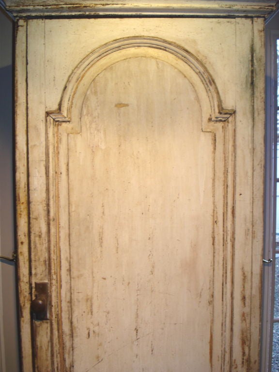An unusual single door cabinet on wonderful large 'onion feet' with a distressed oyster white painted finish; 3-shelf interior.