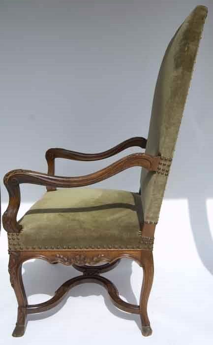 Beautifully detailed 19th century walnut Regence style armchair upholstered in green linen velvet.