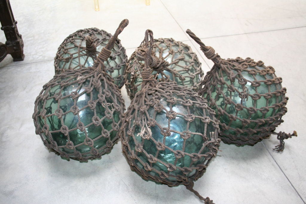 Set of five Japanese glass fishing floats from the 1930's, hand-blown, originally used to keep fishing nets afloat.