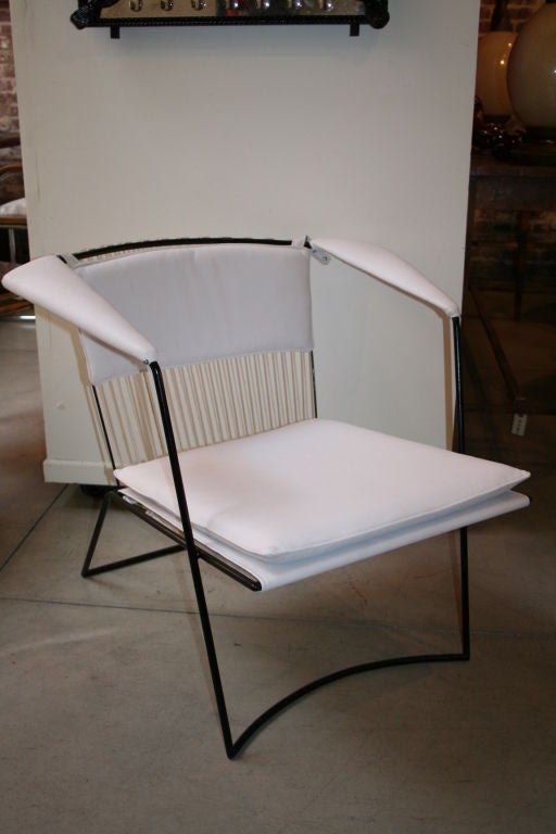 Pair of 1950s extremely elegant and comfortable Joaquim Tenreiro Brazilian white armchairs, iron frame with twine back, seat, armrests and back with loose leather-upholstery cushions. The chairs were published in the book "Tenreiro" by