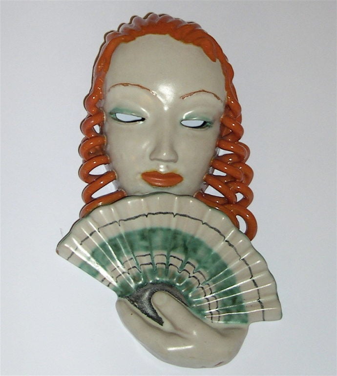 These two wall masks may be purchased as a set or individually. They were made is Austria pre-1934 and have fantastic hand applied glazes. The woman with the fan is 10