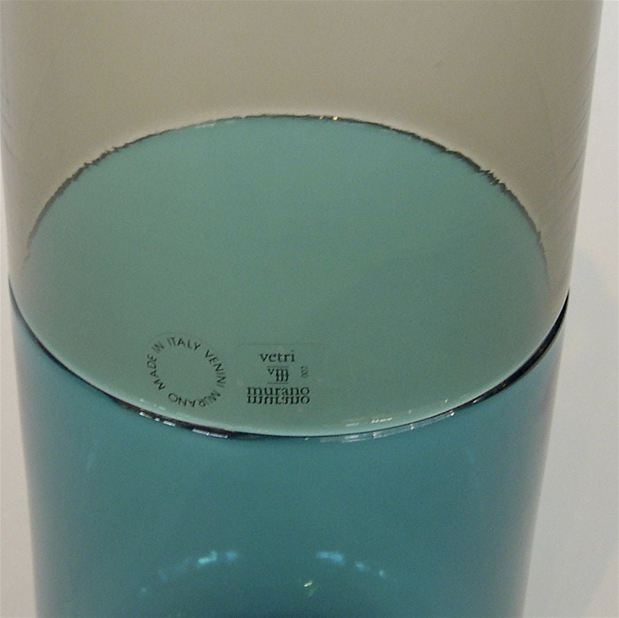 This amazing bottle still retains it's original factory decals. The combination of smoked and aqua blue glass is very striking. It is etched with Venini, the date and 