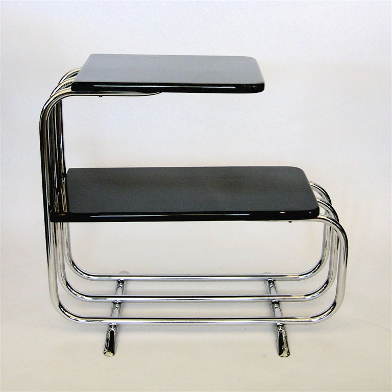 These amazing side tables were designed by Alfons Bach in 1934 and produced by Lloyd's Manufacturing. They have been perfectly restored in hand polished black lacquer and have excellent original chrome.
