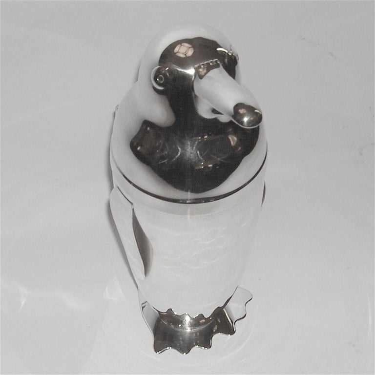 A true classic, this 1930's penguin cocktail shaker is in fantastic condition. The modern style and whimsical demur of this piece make it a must have for your bar collection. It is signed on the underside 