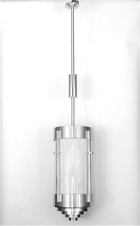 We have two of these great lights. Each one holds four bulbs, three near the top and one near the bottom. The frames and stem are made of aluminum and there is a large, thick white glass tube insert. The stems can be either shortened or lengthened