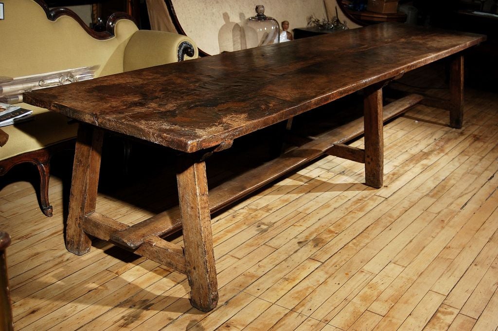 A Large Italian Walnut Convent Table from Lombardy, C. 1737 with<br />
a Trestle Base and An Old Repair to Top. (date engraved in one end)