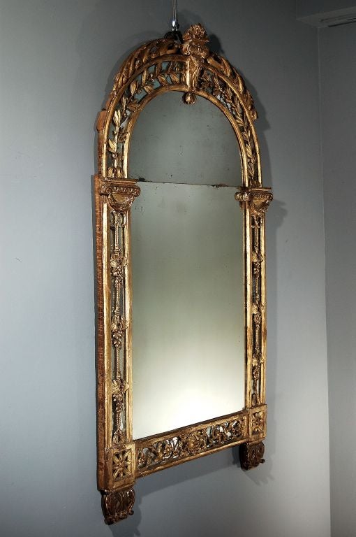 A Beautiful French Carved and Water Gilded Mirror of Arch Form with Carved Grapevine and Laurel Leaf Motifs, Original Glass. Circa 1760-70