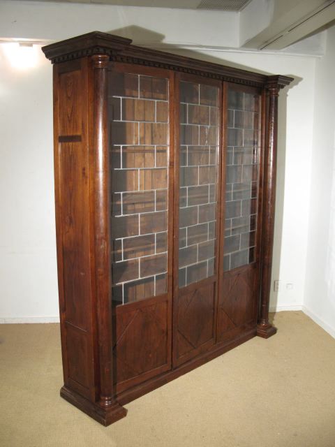 An Italian Library Cabinet with Adorsed Columns and Dentil Molding. Leaded Glass Cabinet Doors.  Circa1920's
