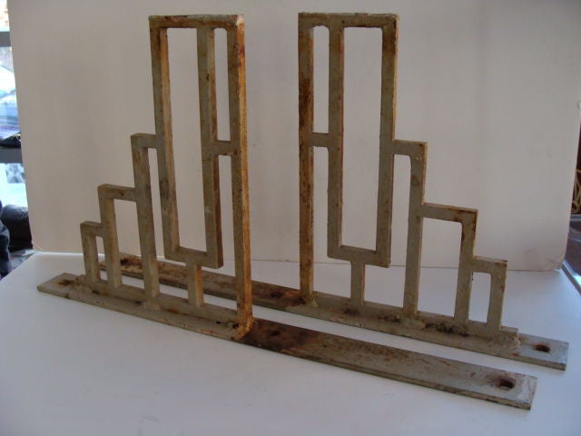 Very stylish pair of cast iron brackets in a geometric pattern typical of Art Deco period.  Fantastic with a glass shelf.