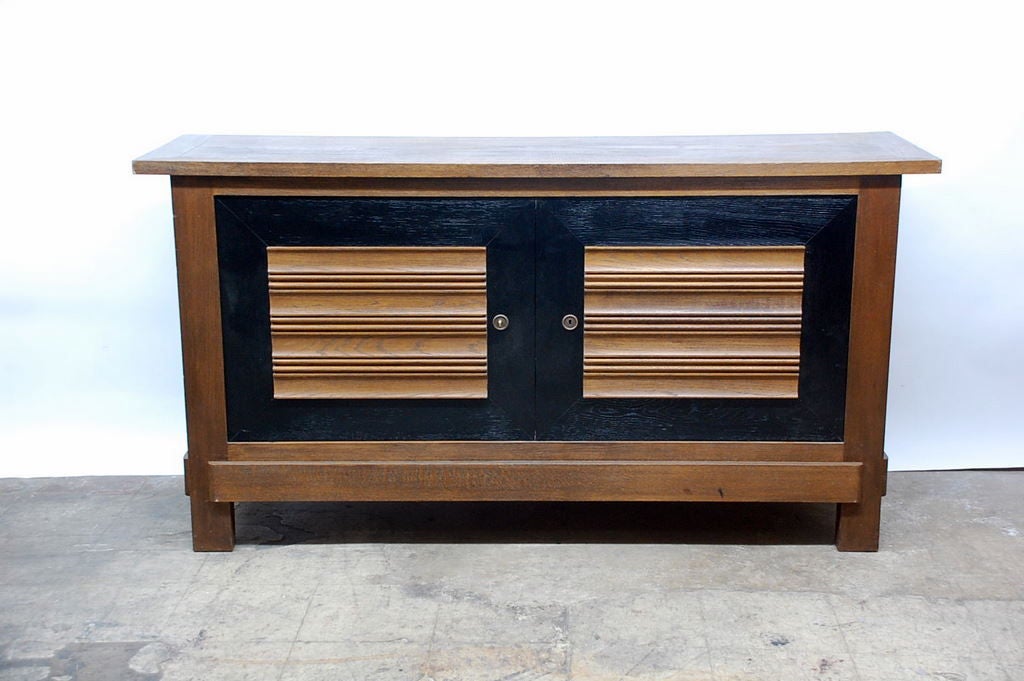 French oak sideboard by Charles Dudouyt for La Gentilhommière. One shelf with two middle drawers. Secret compartment under the lower drawer (found by chance).

Background information in French (from a letter from his grandson):

Charles