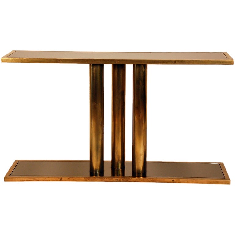 Bronze tinted mirror panels inserted into a patinated brass base. The 'Calandre' console is perfect for a chic modern entryway or a living or dining room.