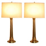 Pair of tall bronze console lamps with custom oval shades