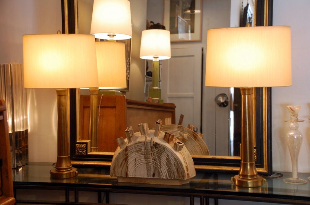 Pair of tall bronze console lamps with custom oval shades