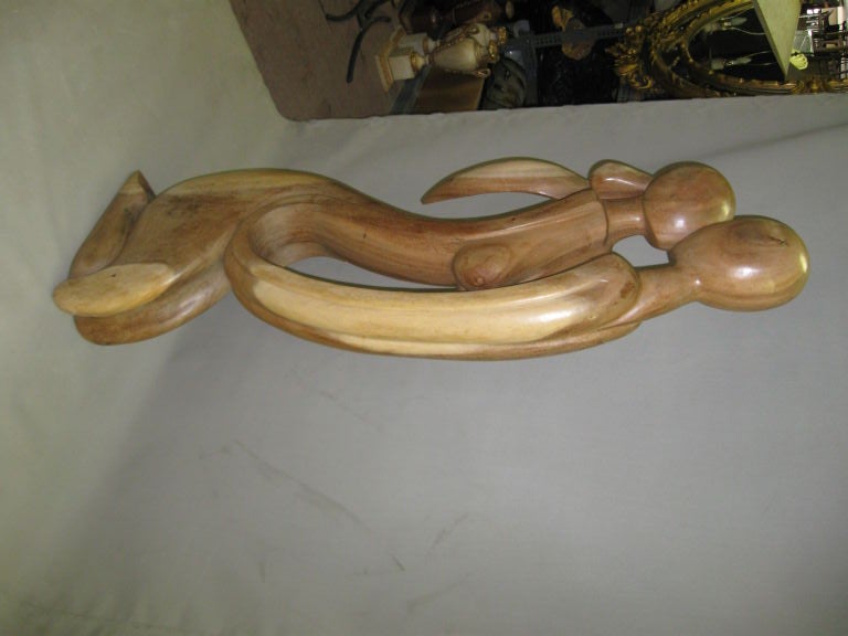 WOOD SCULPTURE OF A COUPLE KISSING