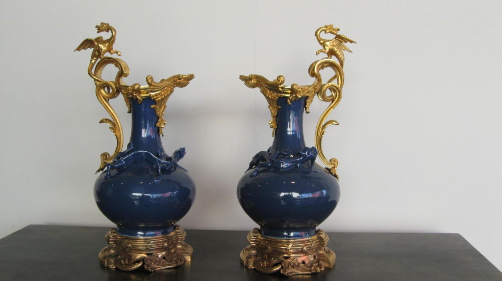 PAIR OF FRENCH GILT-BRONZE MOUNTED BLUE GLAZE PORCELAIN<br />
BOTTLE FORM VASES, DECORATED WITH LIZARDS/SALAMANDERS. GILDED DRAGON HANDLES.