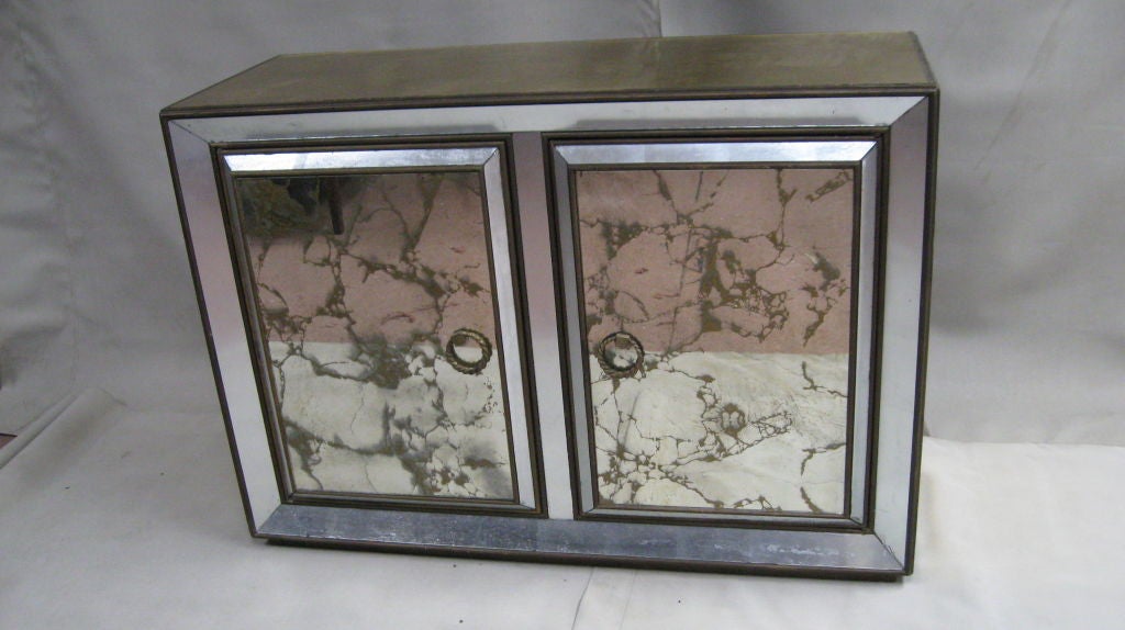 GOLD AND SILVER LEAF GLASS COMMODE.