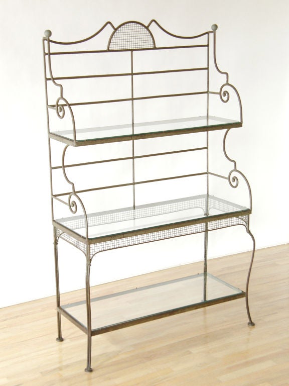 Iron baker's rack with scrolled sides and woven wire by Woodard.
