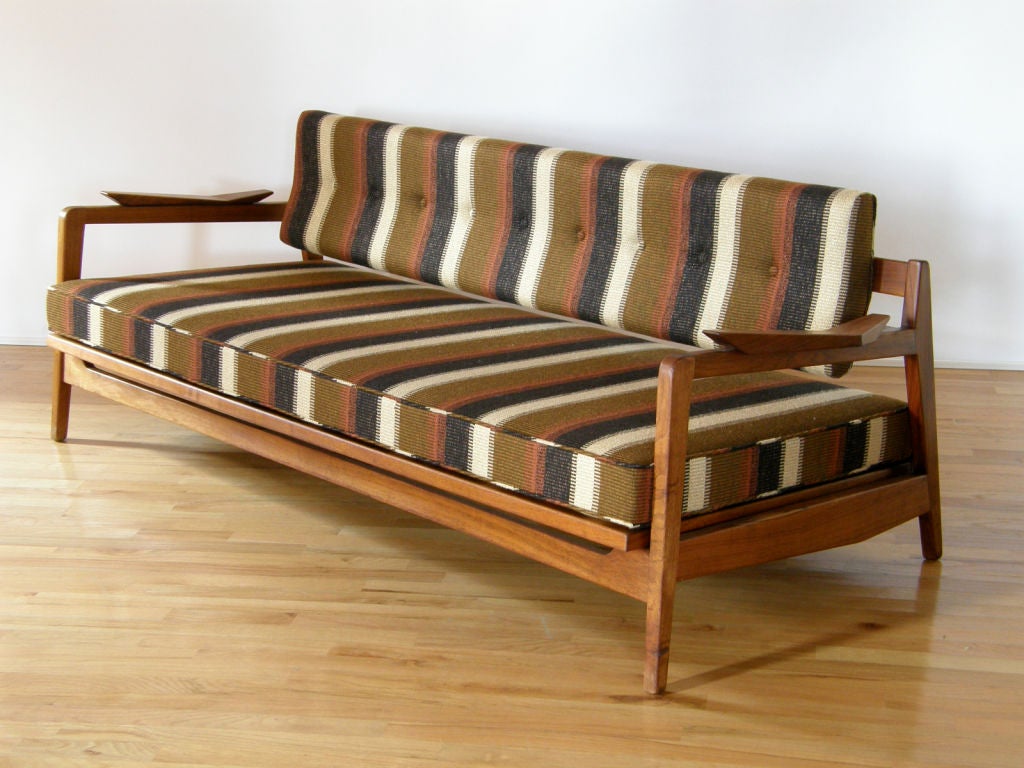 Walnut framed sofa/daybed designed and produced by Jens Risom. Platfrom seat cushion lifts and levels to serve as daybed.