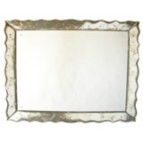 Monumental wall mirror with scalloped glass frame