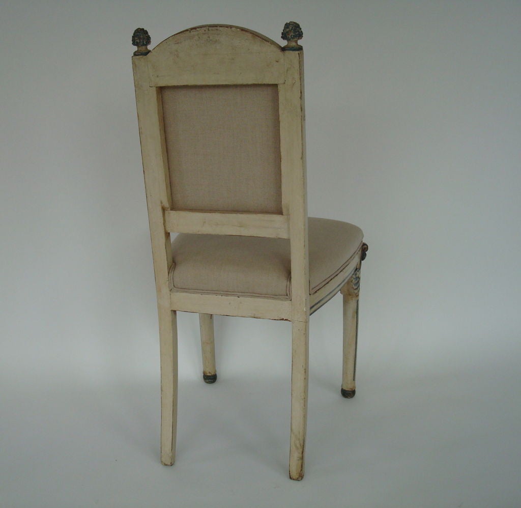 Pair of hand carved italian side chairs. Carved swans embellish the legs.<br />
Reupholstered in belgian linen.