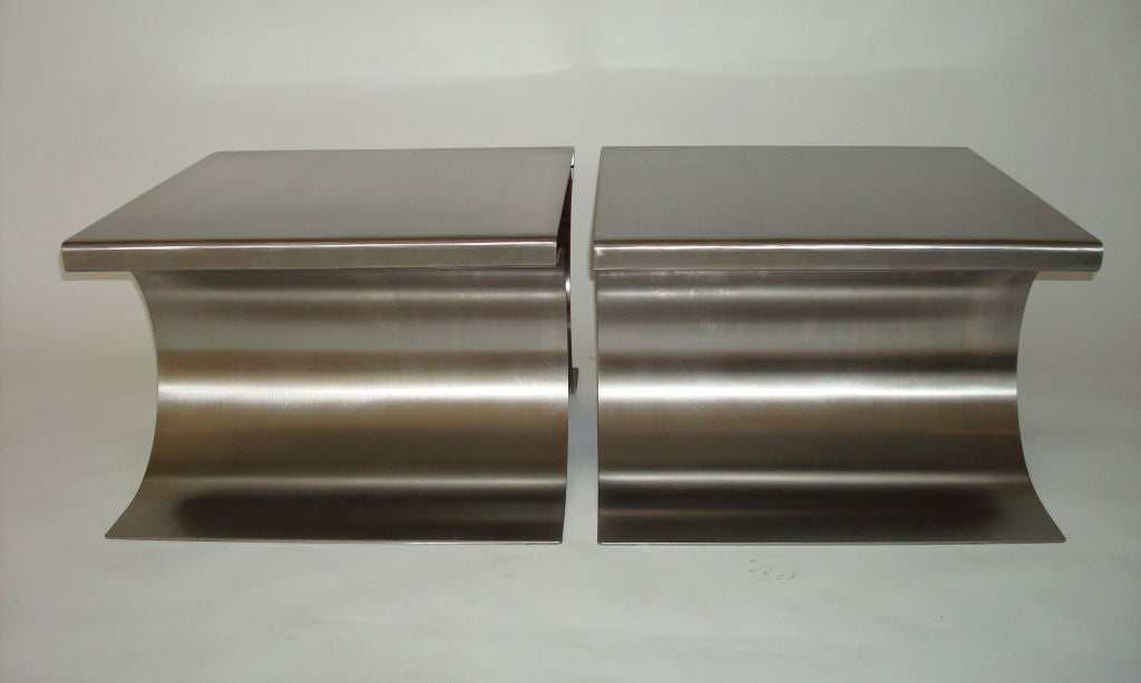 Michel Boyer “X” Stools or Coffee Tables<br />
Pair of stainless steel folded x forms stools by French designer Michel Boyer. These were designed by Boyer to be used as stools with a cushion or inverted and used as coffee table with glass plateau.