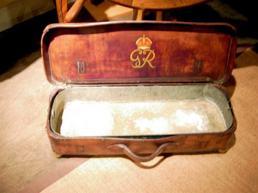 Handsome and unusual 19th century leather case on brass ball feet fitted with a metal liner.