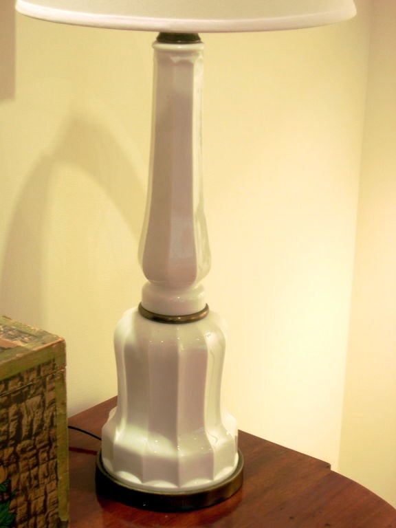 A pair of Charles X style, molded white glass, fluted, columnar form table lamps, attributed to Paul Hanson. Three way sockets and wiring are new. <br />
Ca 1960