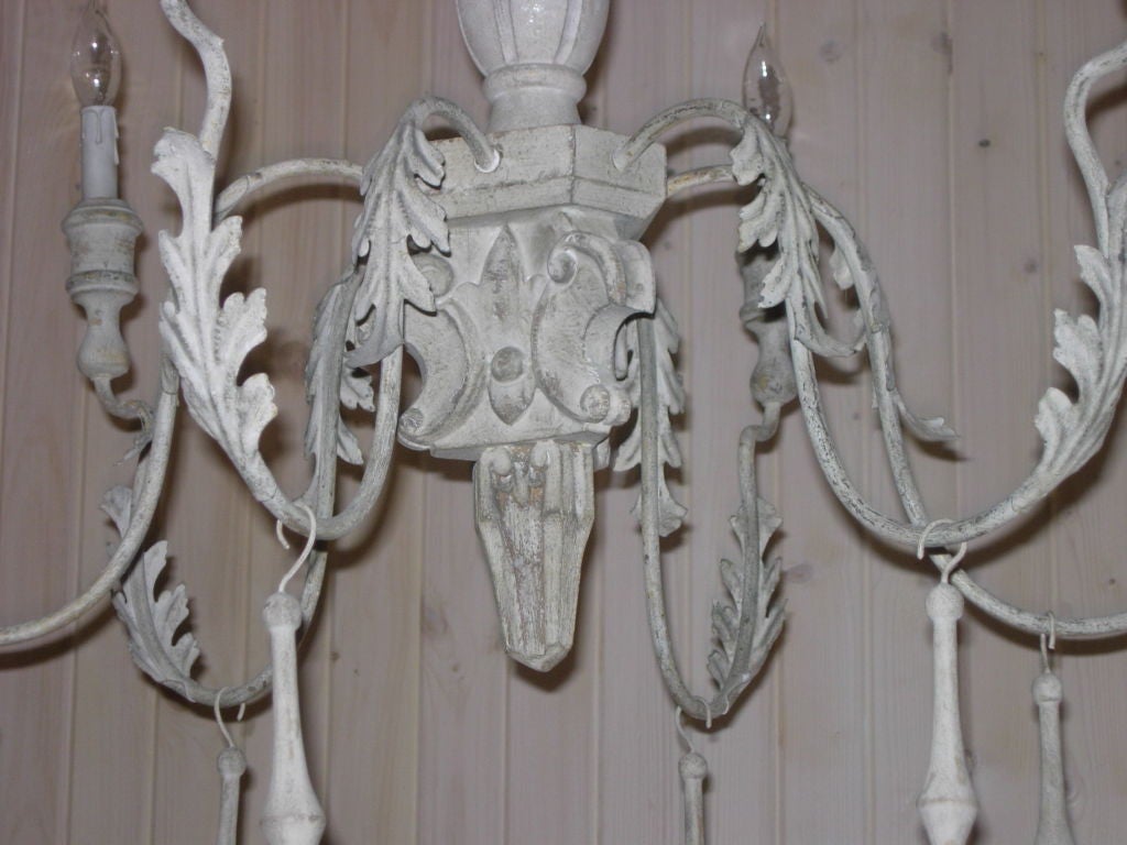Pair of elegant Italian style carved wood and tole chandeliers, nice distressed painted finish. Priced per chandelier.