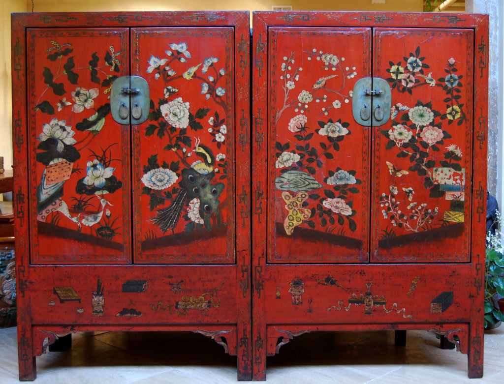 Pair of cabinets lacquered in red with unusual provincial style folk wucai paintings of birds and auspicious flowers including lotus and chrysanthemums.<br />
<br />
Pagoda Red Collection #:  DVA012<br />
<br />
<br />
Keywords:  Cabinet,