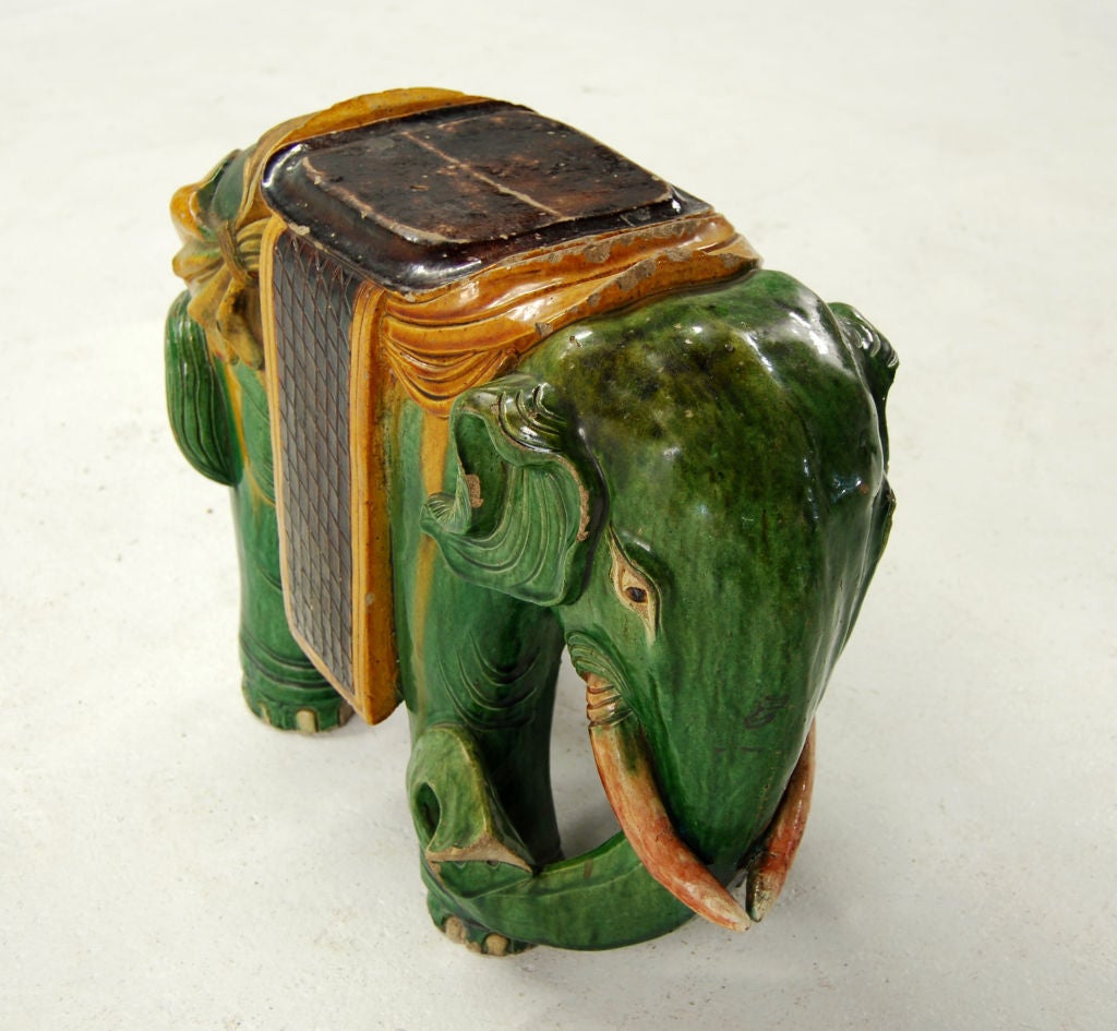 Small ceramic garden stool depicting an elephant in traditional 19th century Chinese spinach and yellow glazes.<br />
<br />
<br />
Keywords:  End table, side table, stool.