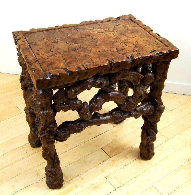 This rare, natural form root wood side table has a pierced ornate apron and marquetry-styled top that creates a beautiful, interlocking pattern. Naturally contorted wood has been appreciated in China for millennia. The organic forms appealed to