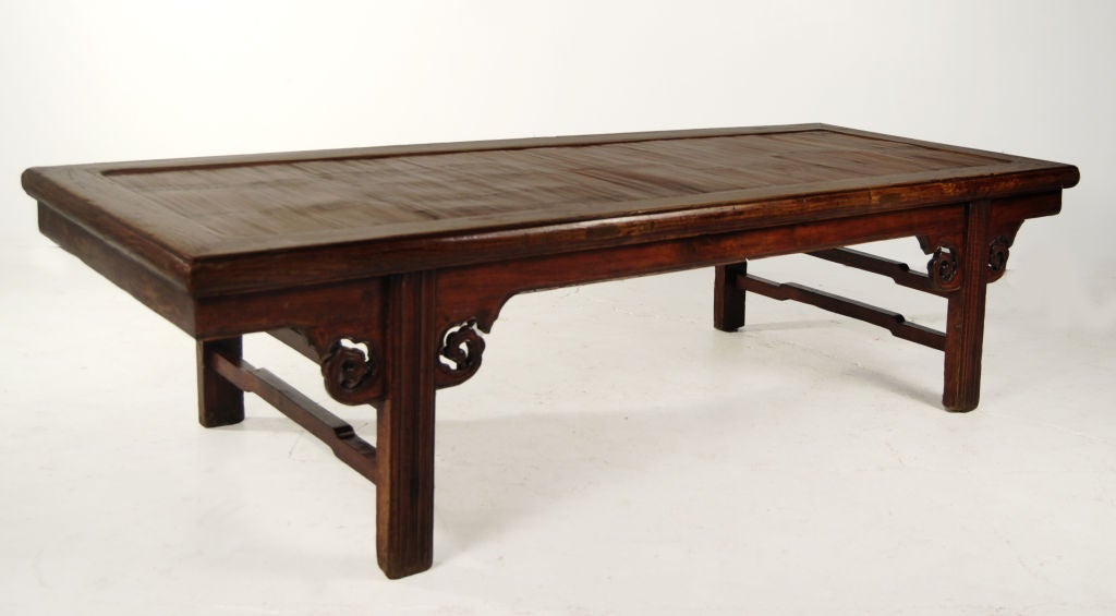 A 19th century Chinese long low elmwood table with crushed bamboo top and carved billowing cloud spandrels.<br />
<br />
Pagoda Red Collection #:  QQQ091<br />
<br />
<br />
Keywords:  Table, low, cocktail, coffee, chaise, day bed, daybed