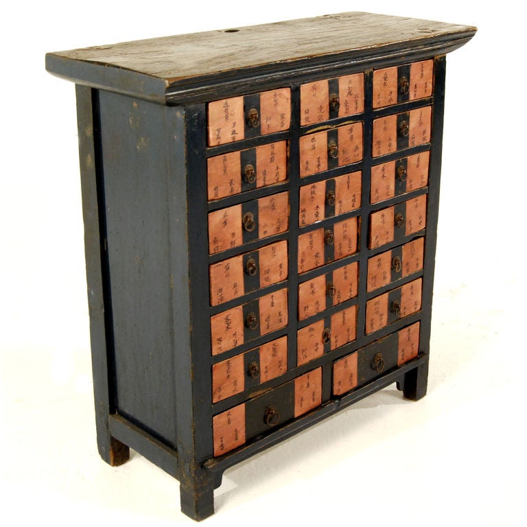 An early 19th century Chinese apothecary cabinet with indigo lacquered sides and red paper labels on the drawers describing the contents originally contained within.

Pagoda Red Collection #:  X057


Keywords:  Cabinet, chest, chest of drawers,