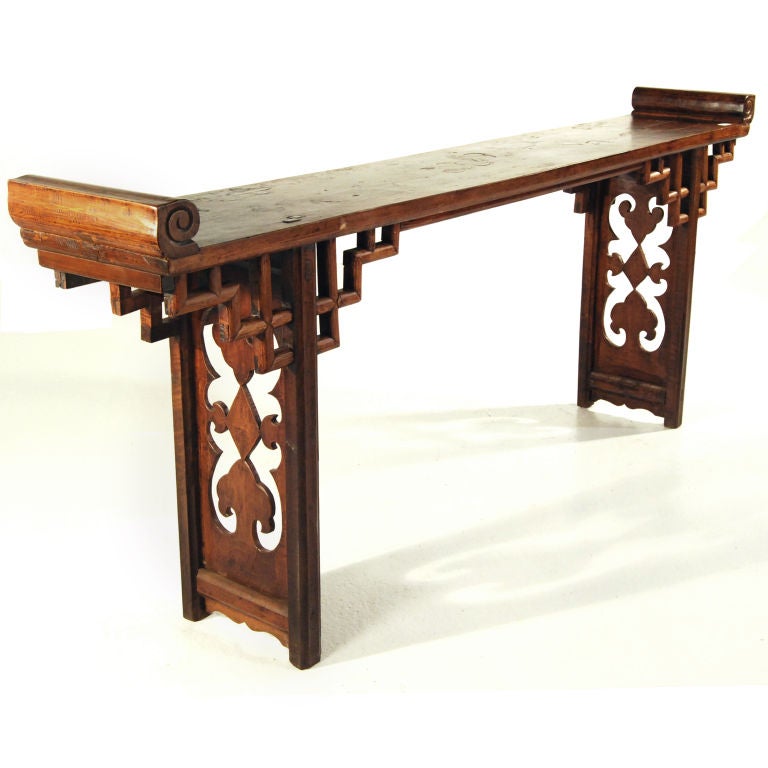 A 19th century Chinese pearwood altar table with ornate apron of geometric design, intricately carved leg panels with Ruyi and diamonds, and old pieced repairs on top depicting auspicious symbols.

Pagoda Red Collection #:  X063

Keywords: 