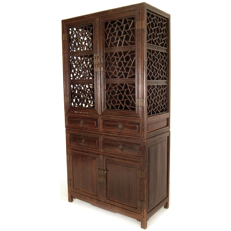 A 19th century Chinese stacking kitchen cabinet with cracked ice patterned lattice doors and four drawers, with brass hardware from China's 