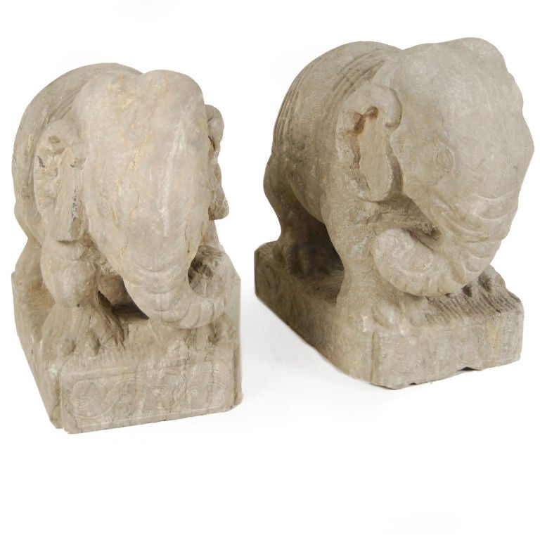 A pair of early 20th century limestone elephants with carved bases and swinging trunks, from China's Yunnan Province.<br />
<br />
Pagoda Red Collection #:  X005<br />
<br />
<br />
Keywords:  Stone, limestone, carved, statue, sculpture,