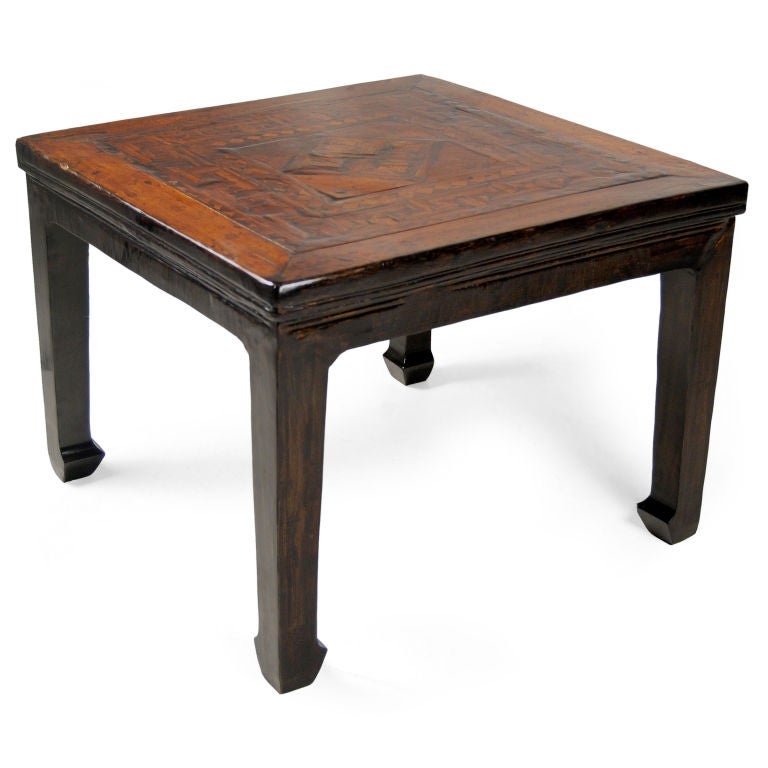An early 20th century Chinese elmwood low table with burl parquetry inlay, and black lacquered legs with horse hoof feet.<br />
<br />
Pagoda Red Collection #:  CAF090<br />
<br />
<br />
Keywords:  Side table, end, low, coffee, cocktail,