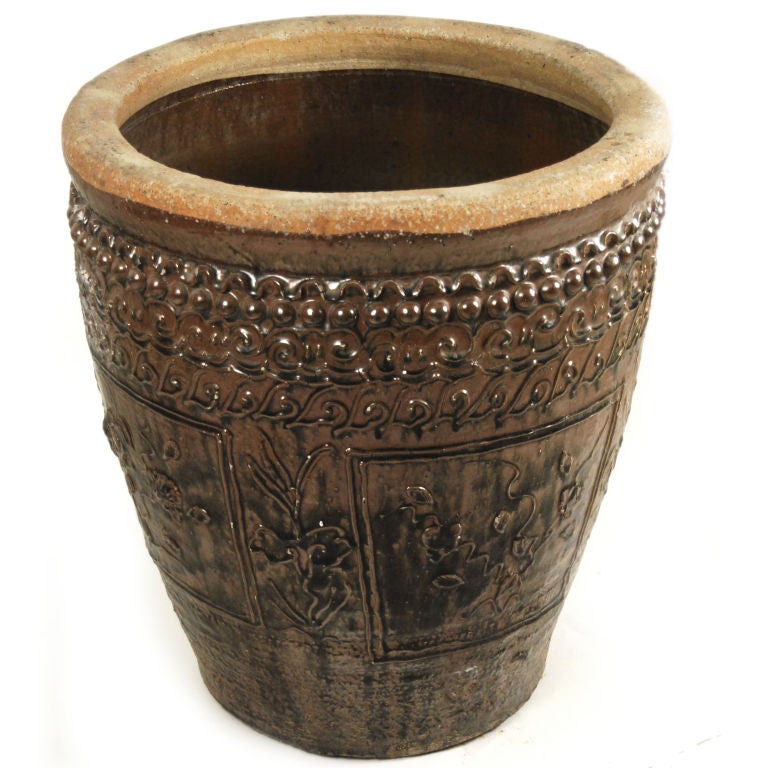 An early 20th century Chinese glazed ceramic urn with hand-sculpted floral relief pattern.

Pagoda Red Collection #:  U065

Keywords:  Urn, jar, pot, pottery, planter, garden, jardiniere, patio