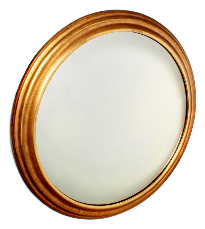 This is a high quality wooden round gold gilt mirror.  It came from the Marshall Fields Emporium.