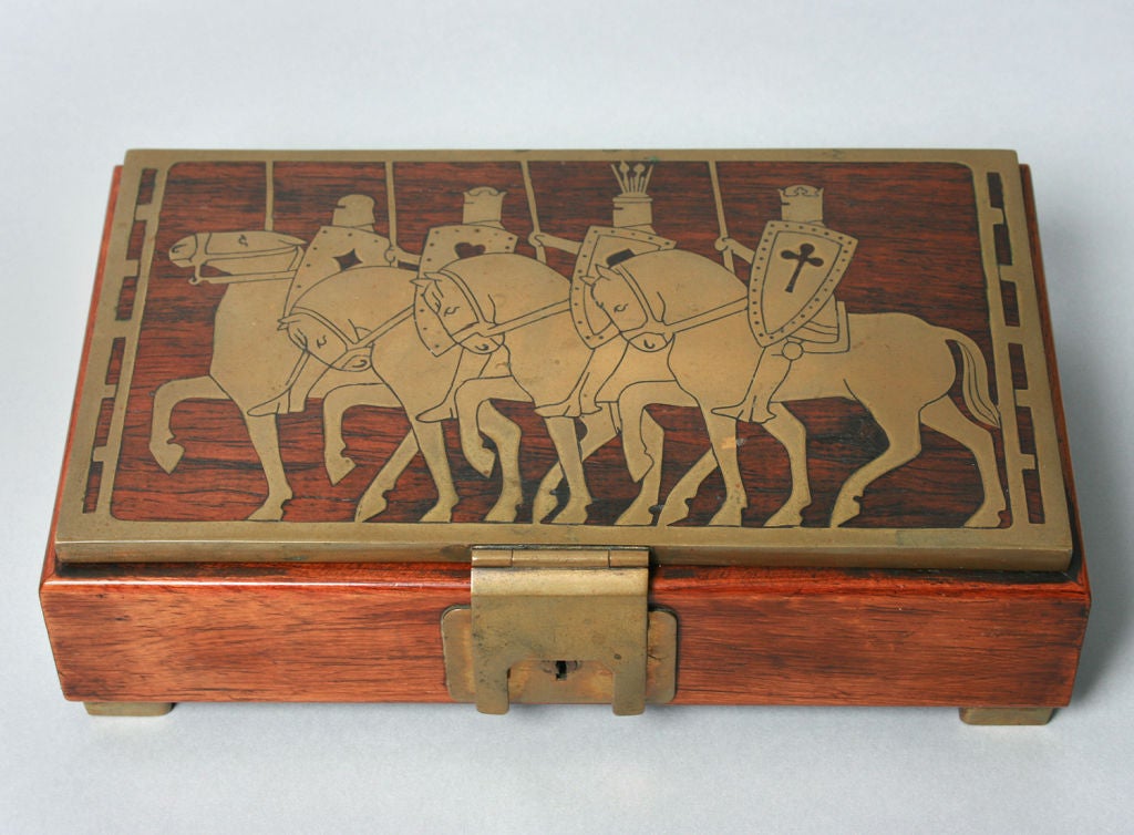 This is a very handsome men's box, inlaid with brass, depicting knights on their steeds. We've been told it was made by Ehrhard and Sons of Germany.